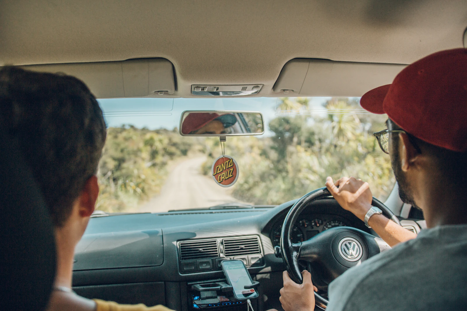 Two people sharing a sunlit journey in a car